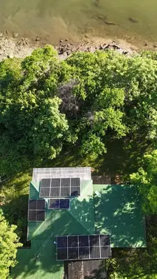 an overhead view of a house with solar panels at Teak house in a forest above the beach