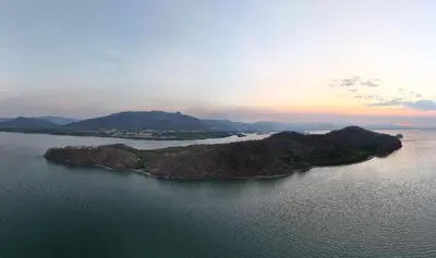 an island in the middle of a large body of water at Teak house in a forest above the beach