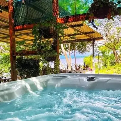 Teak house in a forest above the beach
