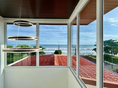 a room with windows and a view of the ocean at Playa Hermosa 44 - Beach House Getaway in Playa Hermosa