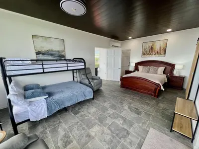 a room with a bunk bed and a bedroom with a bed sqor at Playa Hermosa 44 - Beach House Getaway in Playa Hermosa
