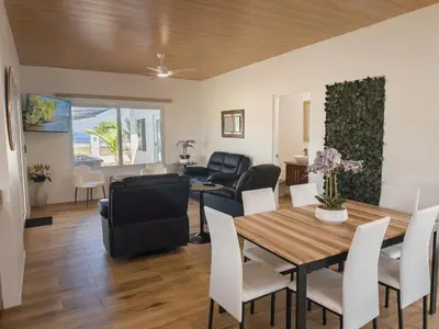 a dining room and living room with a table and chairs at Playa Hermosa 44 - Beach House Getaway in Playa Hermosa