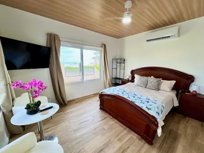 a bedroom with a bed and a table and a window at Playa Hermosa 44 - Beach House Getaway in Playa Hermosa