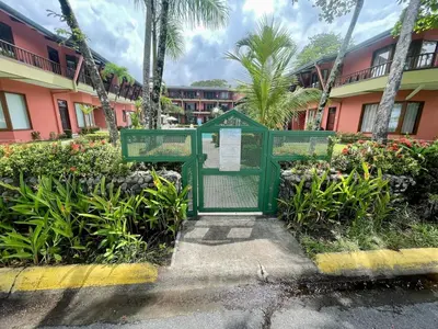 a green sign in front of a building at Beachfront apartment in Jacó in Tapantí
