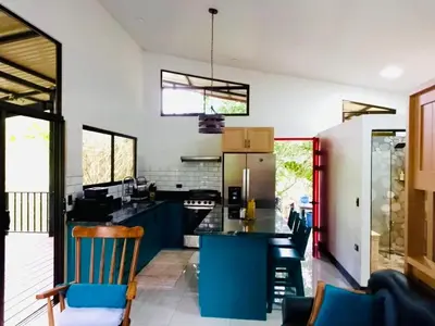 a kitchen with blue cabinets and a counter top at Rio Breeze