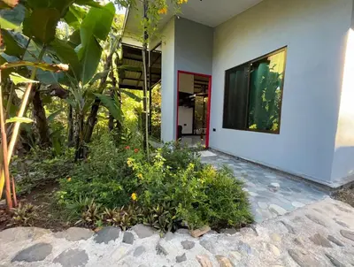 a house with a large window and some plants at Rio Breeze