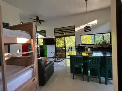 a living room with a couch and a table and chairs at Rio Breeze