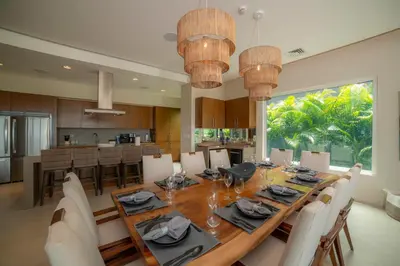 a dining room and kitchen with a table and chairs at Casa Ohana 5 bdrs ocean view in Los Suenos in Herradura