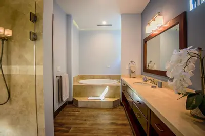 a bathroom with a tub and a sink and a shower at Casa Aurora 5 bdr private pool in Los Sueños in Herradura