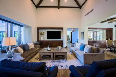a large living room with couches and a tv at Casa Aurora 5 bdr private pool in Los Sueños in Herradura