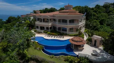 an aerial view of a mansion with a swimming pool at Casa Garmus 10 bdrs ocean views in Los Suenos in Herradura