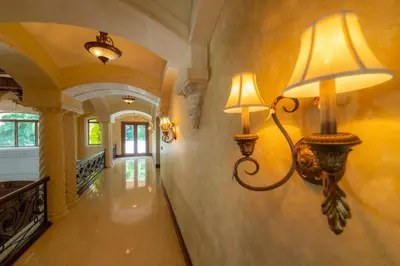 a hallway with two lights on the wall at Casa Garmus 10 bdrs ocean views in Los Suenos in Herradura