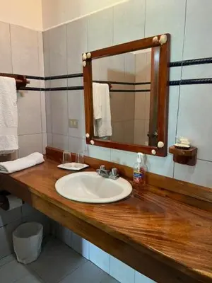 a bathroom with a sink and a mirror at La Ensenada Lodge in Abangaritos