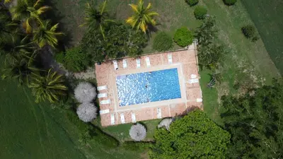 an aerial view of a building with a swimming pool at La Ensenada Lodge in Abangaritos