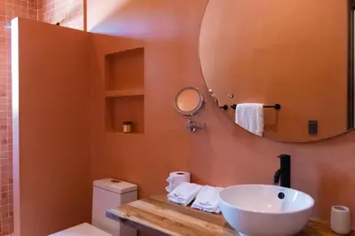 a bathroom with a sink and a mirror at Nakama Nosara in Nicoya