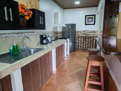 a kitchen with a sink and a counter top at Charming Small House, Near the beach & Waterfalls in Platanillo