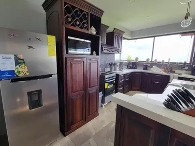 a kitchen with a stainless steel refrigerator and a counter at A place to create dreams in Naranjo