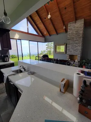 a kitchen with a counter top and a large window at A place to create dreams in Naranjo