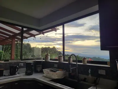 a kitchen with a window with a view of the mountains at A place to create dreams in Naranjo