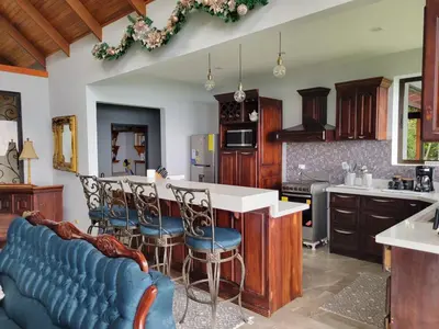 a kitchen with a table and chairs in a kitchen at A place to create dreams in Naranjo