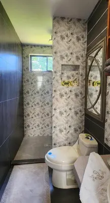 a bathroom with a toilet and a shower at A place to create dreams in Naranjo