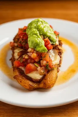 a sandwich with guacamole on a white plate at Hotel Mirador Mayday Mountain View in Alajuela City