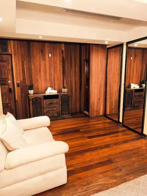 a living room with a white couch and wooden walls at Hotel Mirador Mayday Mountain View in Alajuela City
