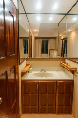 a bathroom with a sink and a large mirror at Hotel Mirador Mayday Mountain View in Alajuela City
