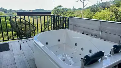 a bath tub sitting on top of a balcony at BiBO Casa Savia in Monteverde Costa Rica
