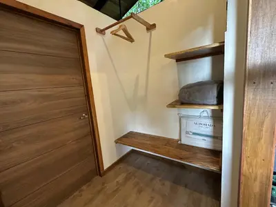 a room with a closet with a wooden door at BiBO Casa Savia in Monteverde Costa Rica