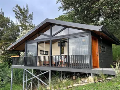 a small house with a screened in porch and windows at BiBO Casa Savia in Monteverde Costa Rica