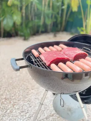 a bunch of hot dogs cooking on a grill at Beach House & Resort Amenities at Ciudad del Mar Jaco in Jacó