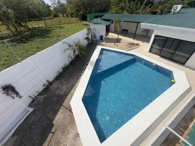 an overhead view of a swimming pool next to a house at Luxury Home Tamarindo 3BR- 4BA and Private Pool in Tamarindo