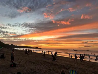 a group of people on a beach at sunset at Luxury Home Tamarindo 3BR- 4BA and Private Pool in Tamarindo