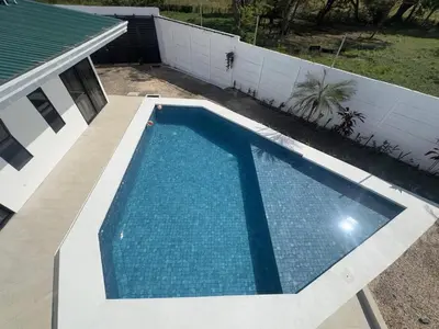an empty swimming pool in a yard next to a house at Luxury Home Tamarindo 3BR- 4BA and Private Pool in Tamarindo