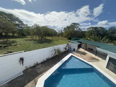 a swimming pool in a yard next to a fence at Luxury Home Tamarindo 3BR- 4BA and Private Pool in Tamarindo