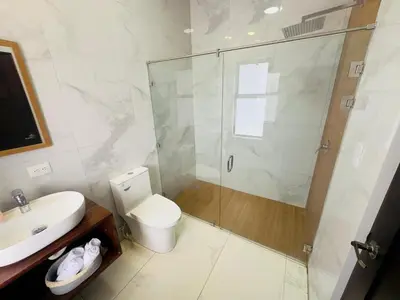 a bathroom with a shower and a toilet and a sink at Luxury Home Tamarindo 3BR- 4BA and Private Pool in Tamarindo