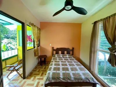a bedroom with a bed and a ceiling fan at Casona de Pani Altillo#10 in Liberia