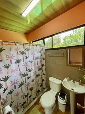 a bathroom with a toilet and a sink at Casona de Pani Altillo#10 in Liberia