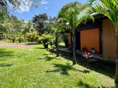 a garden view of a house with palm trees at Casona de Pani Altillo#10 in Liberia