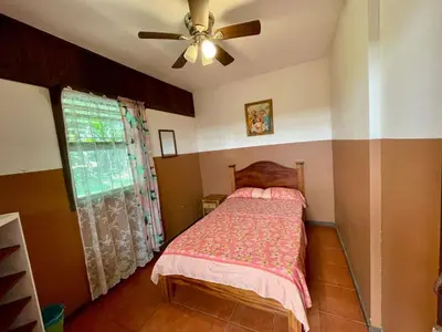 a bedroom with a bed and a ceiling fan at Casona de Pani habitacion#2 in Liberia