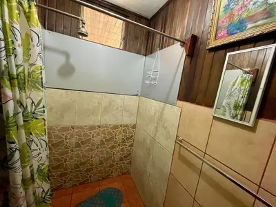 a shower with a glass door in a bathroom at Casona de Pani habitacion#2 in Liberia