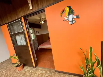 a room with an orange door with a bird on it at Casona de Pani habitacion#2 in Liberia