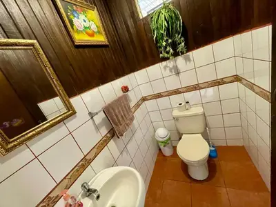 a bathroom with a toilet and a sink and a mirror at Casona de Pani habitacion#2 in Liberia