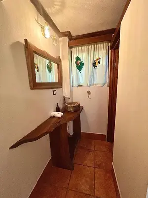 a bathroom with a wooden table and a window at Rio Lindo Hotel in Dominical