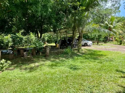 a house with a car parked in a yard at Casona de Pani habitacion#3 in Liberia