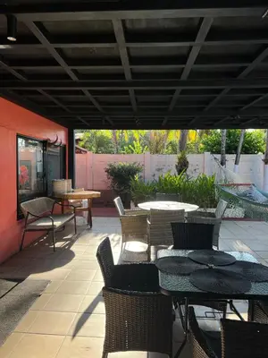 an outdoor patio with tables and chairs and a table and chairs at Jane's Beach Resort in Chacarita