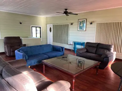 a living room with blue couches and a coffee table at Jane's Beach Resort in Chacarita
