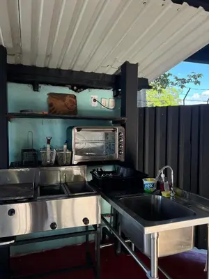 a kitchen with a sink and a microwave at Jane's Beach Resort in Chacarita