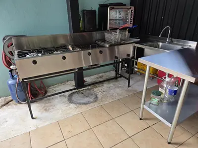 a kitchen with a stove and a sink at Jane's Beach Resort in Chacarita